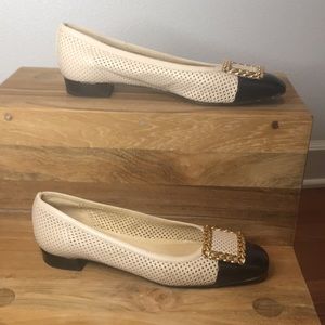 Beige and black Stuart Weitzman flats.